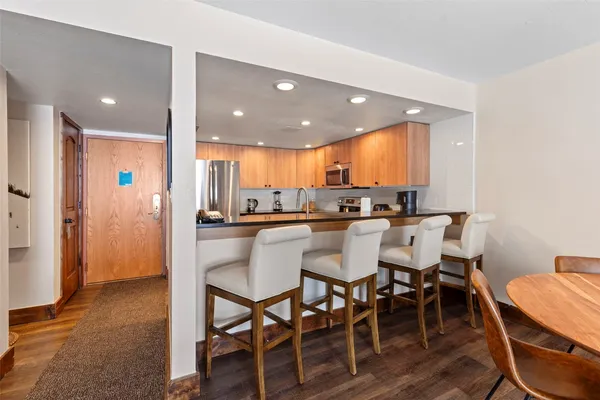 a kitchen with a dining table chairs and view kitchen