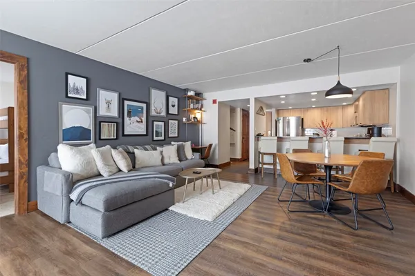 a living room with furniture wooden floor and a table