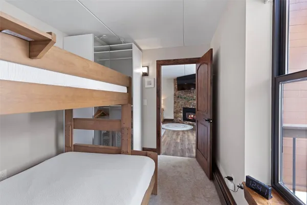 a bedroom with a bed and a mirror