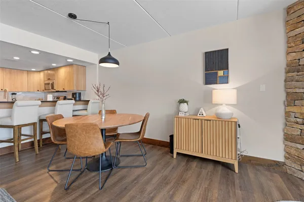a dining room with furniture and wooden floor
