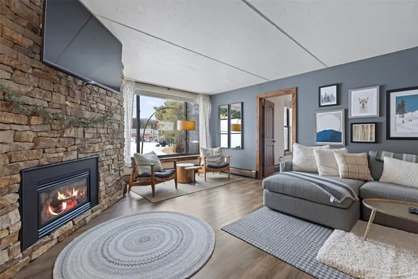 a living room with furniture a window and a fireplace