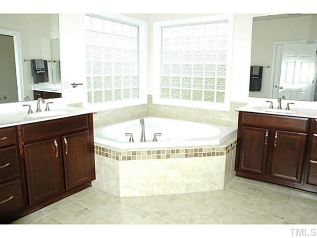 702 Ivyshaw Road Cary, NC 27519 - Photo 16 of 25 Light and airy bath with his/hers separate vanities. Makes getting ready in the morning so much easier Great tub for relaxation! Master Bath/Spa