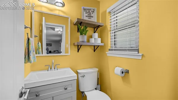 a bathroom with a sink mirror and toilet