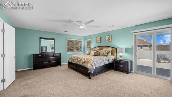 a spacious bedroom with a bed and a chandelier