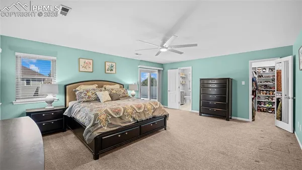 a spacious bedroom with a bed and a walk in closet