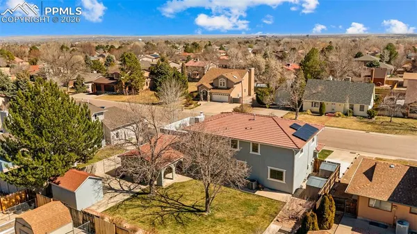 an aerial view of residential houses with outdoor space