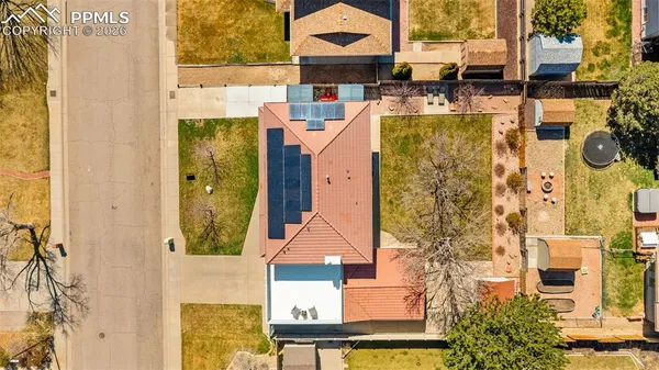 an aerial view of residential houses with outdoor space and parking