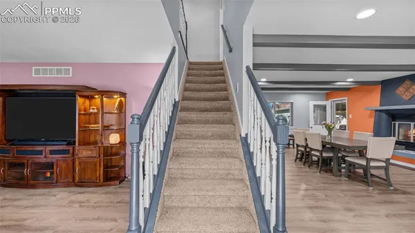a view of a livingroom with furniture and staircase