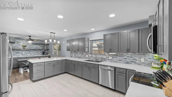 a large kitchen with kitchen island a sink stainless steel appliances and cabinets