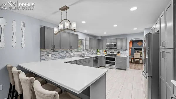 a kitchen with cabinets and stainless steel appliances