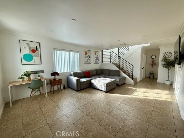 a living room with furniture a rug and a window