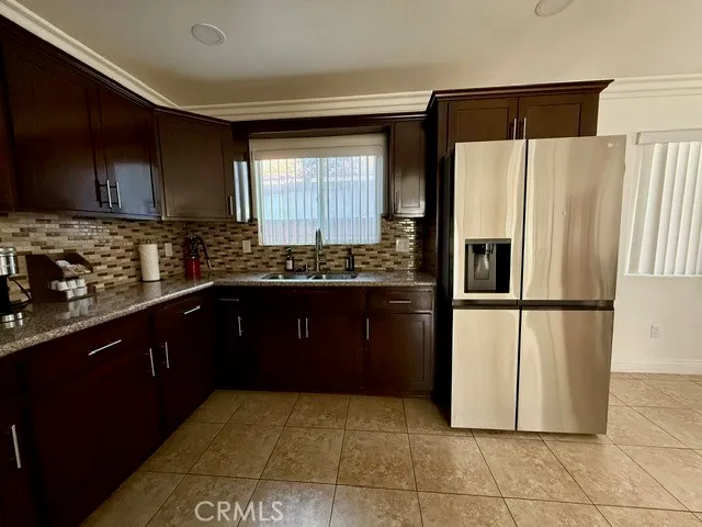 a kitchen with a refrigerator and a sink