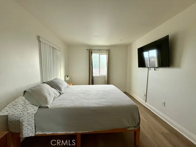 a bedroom with a bed and a flat screen tv