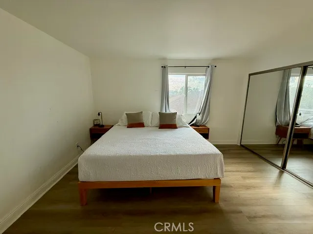 a bedroom with a bed and a mirror