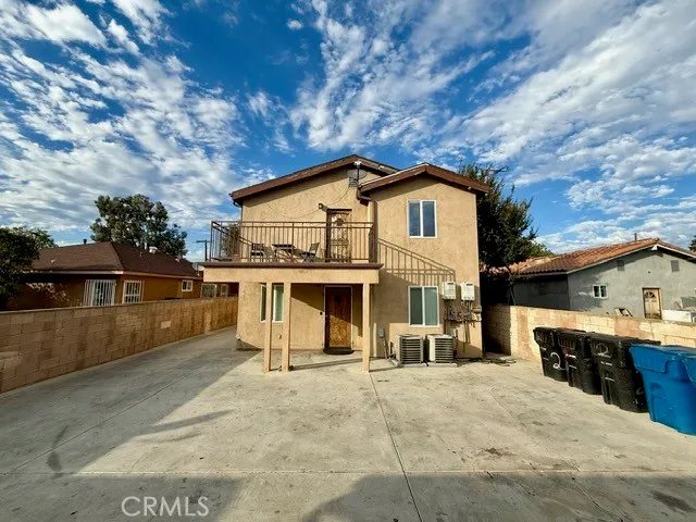 a view of a house with a backyard and balcony