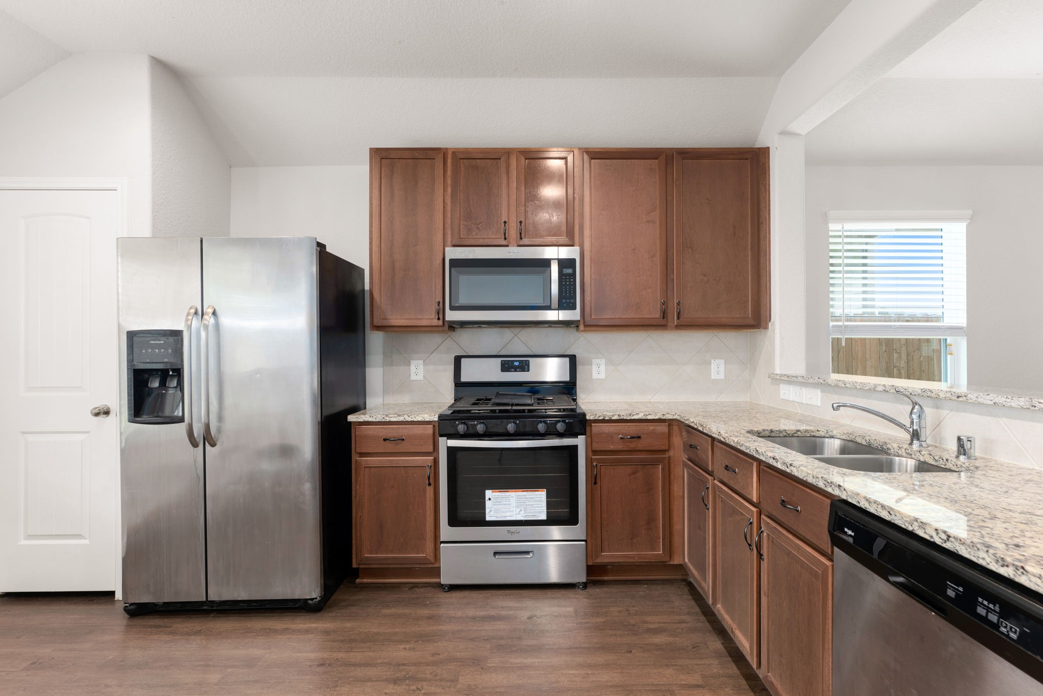 17555 Greystanes Road Humble, TX 77346 - Photo 3 of 28 a kitchen with a sink stove and refrigerator