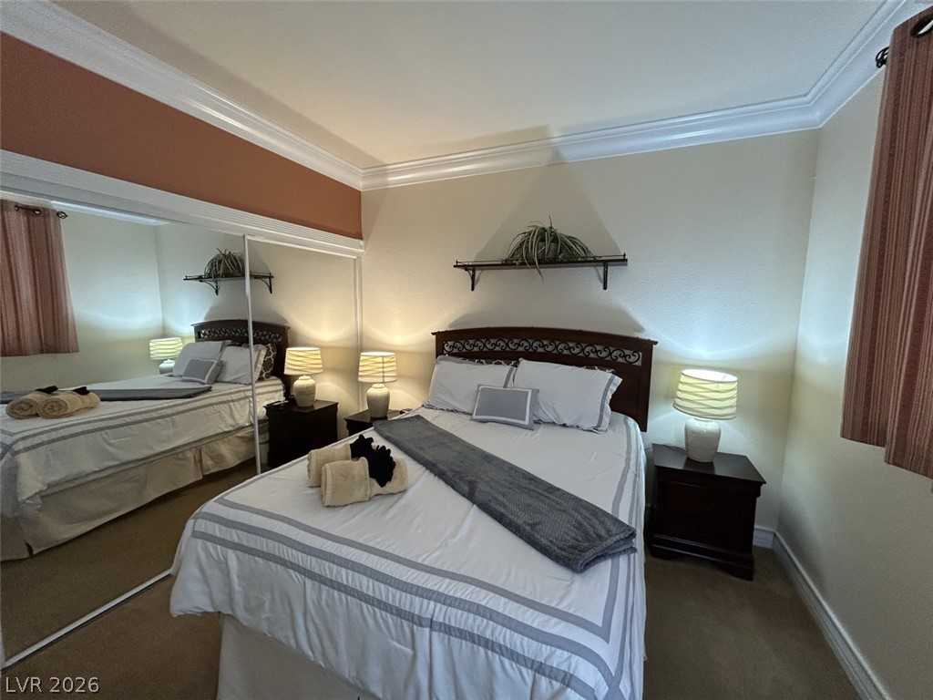 210 East Flamingo Road, Unit 137 Las Vegas, NV 89169 - Photo 14 of 32 This cozy bedroom offers practical mirrored closet doors and neutral carpet.