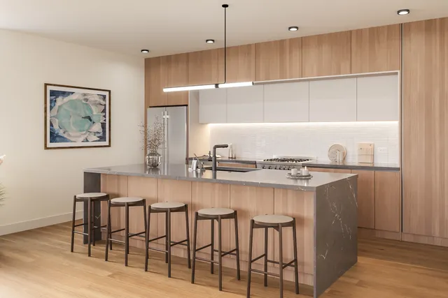 a kitchen with cabinets and chairs