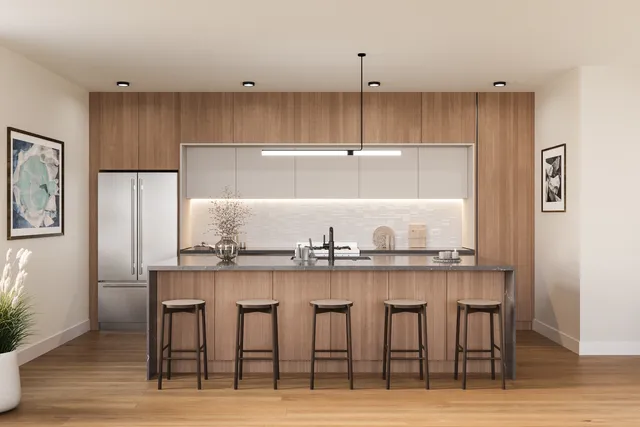 a kitchen with granite countertop a table chairs refrigerator and cabinets