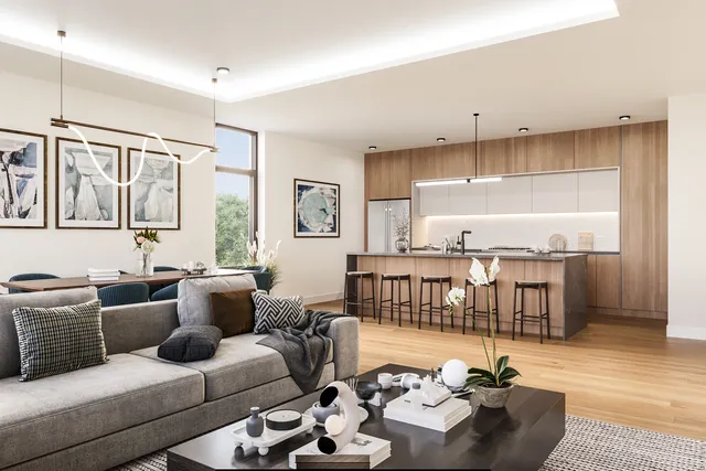 a living room with furniture kitchen view and a window