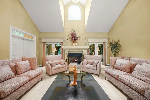 a large kitchen with stainless steel appliances granite countertop a stove refrigerator and cabinets