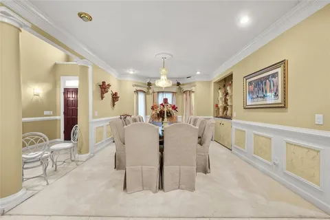 a living room with furniture kitchen view and a large window