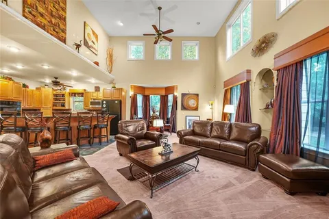 a living room with lots of furniture and a large window