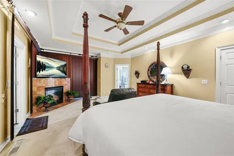 a bedroom with a bed couch and window