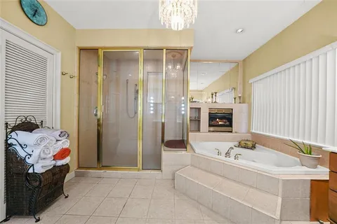 a living room with furniture a flat screen tv and a large window