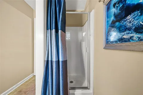 a front view of a house with a garden and trees