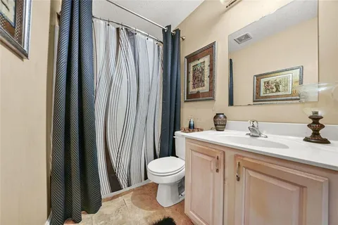 an aerial view of a house with a yard and trees