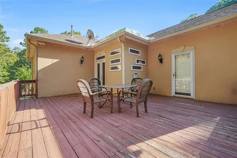 an aerial view of lake residential house with swimming pool and green space