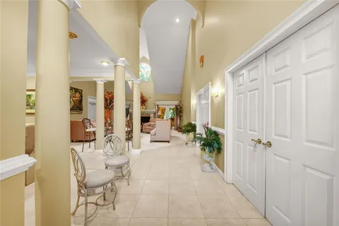 a view of a hallway with dining area and glass door