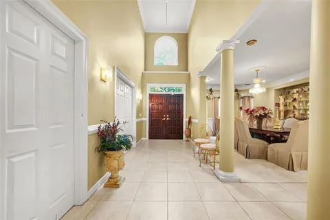 a living room with furniture a chandelier and a fireplace