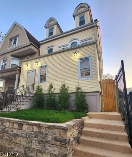 350 13th Avenue Newark, NJ 07103 - Photo 1 of 6 a front view of a house with a yard