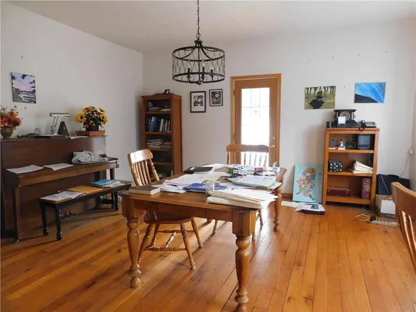 a view of a workspace with furniture and wooden floor