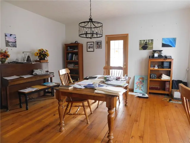 a view of a workspace with furniture and wooden floor