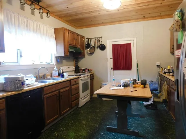 a kitchen with a sink appliances and cabinets