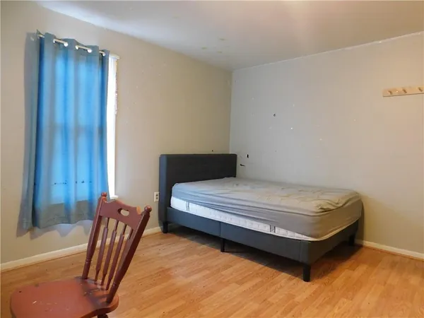 a bedroom with a bed and chair