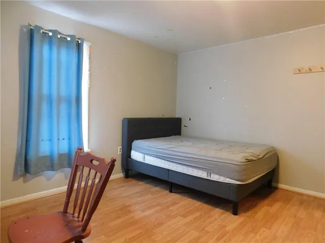 a bedroom with a bed and chair