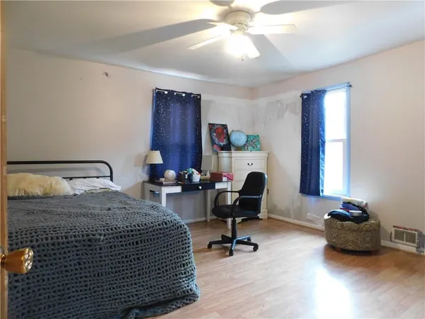 a bedroom with bed and a a chandelier