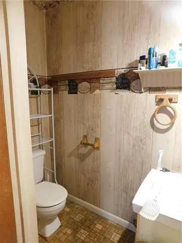 a bedroom with a bed and two windows