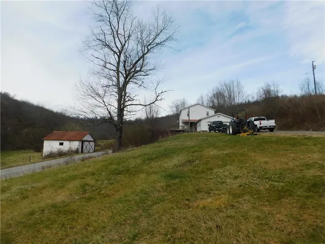 a view of a dry yard with wooden fence