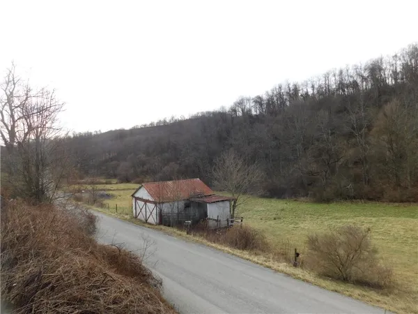 a view of a houses with yard and mountain view