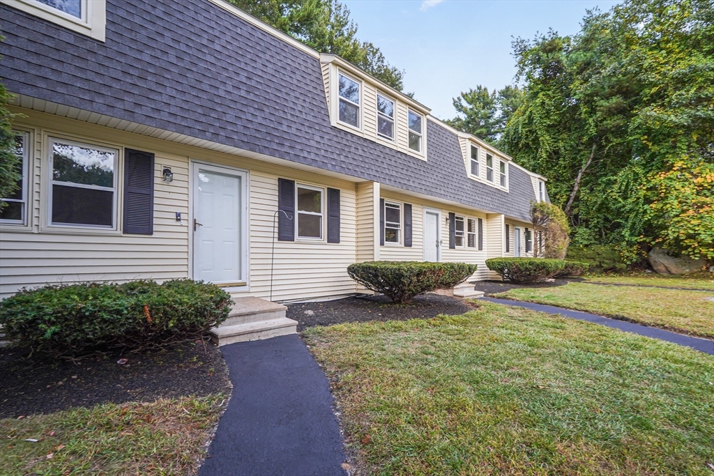 7 Debra Lane, Unit 1 Bellingham, MA 02019 - Photo 1 of 25 a front view of a house with garden