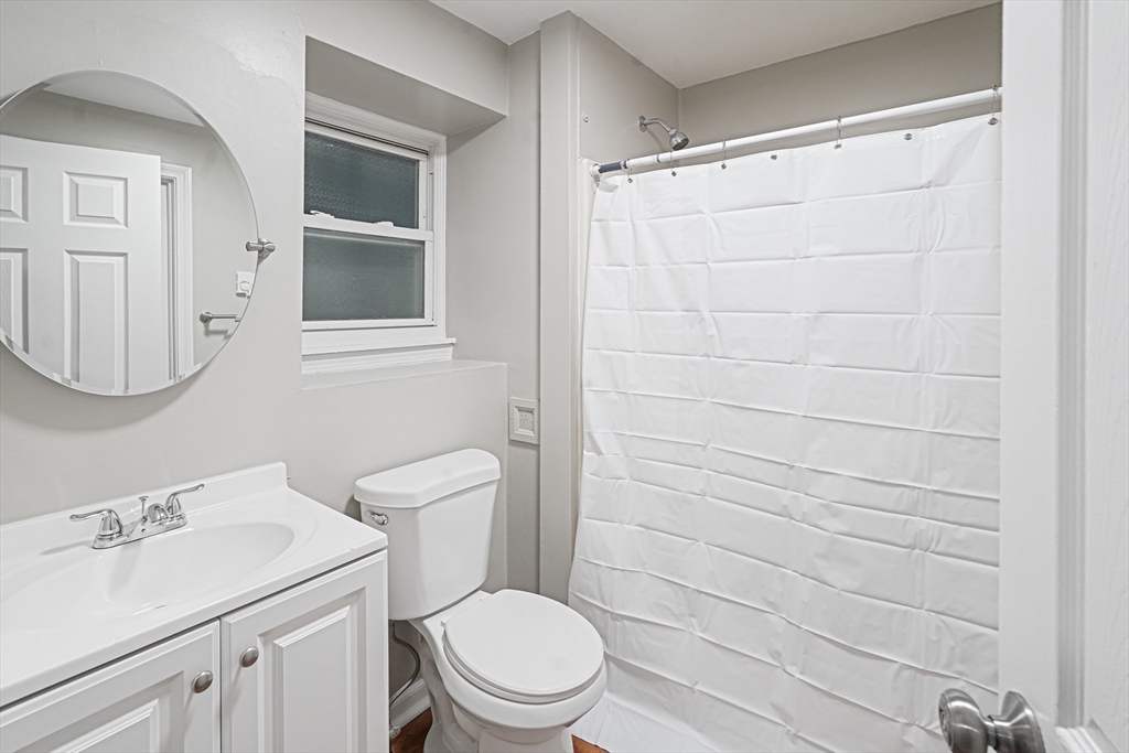 7 Debra Lane, Unit 1 Bellingham, MA 02019 - Photo 12 of 25 a bathroom with a sink a toilet and a mirror