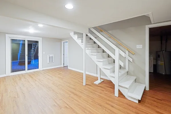 a view of entryway and hall with wooden floor