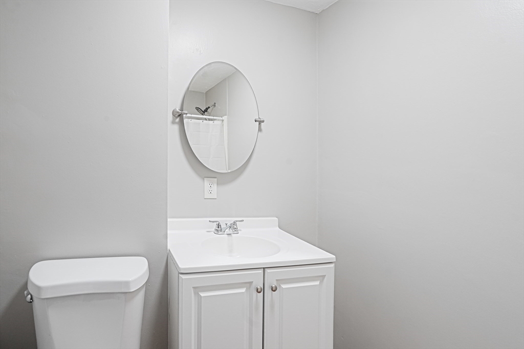 7 Debra Lane, Unit 1 Bellingham, MA 02019 - Photo 24 of 25 a bathroom with a sink a toilet and a mirror