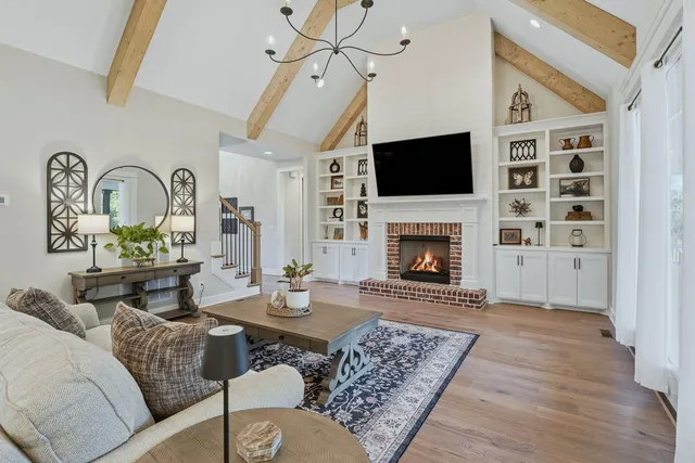 a living room with furniture a flat screen tv and a fireplace