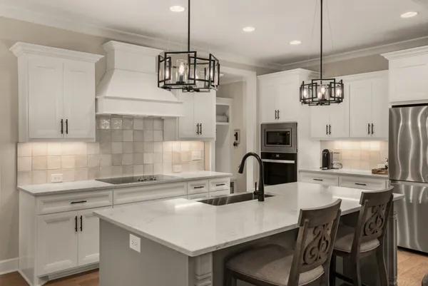 a kitchen that has a lot of windows and chairs